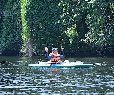 person kayaking on lake